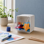 Deflecto Interlocking Single Tilt Bin holding markers and craft supplies on a table