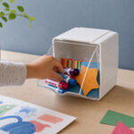 Deflecto Interlocking Single Tilt Bin – a hand taking a marker from the open bin