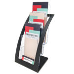 Deflecto DL Portrait Black Curved 3-Tier Brochure Holder filled with DL brochures