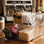Deflecto Stackable Cube 4 Drawer Clear Organiser storing coffee pods and sugar sachets in a café