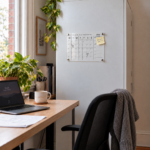 Deflecto A4 magnetic wall planner on a steel cabinet beside a home office desk